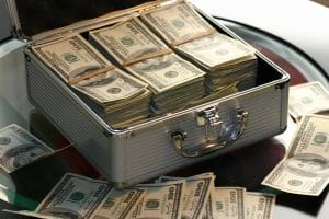 image of cash USD stacked in a lockbox | cashless payment systems at stadiums venues